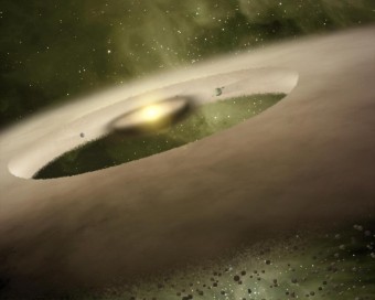 impressione d'artista di una giovane stella circondata da un anello di detriti e da un vasto alone di polveri Credits: NASA/JPL-Caltech