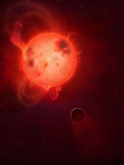 Una rappresentazione artistica del pianeta Kepler-438b e della sua violenta stella madre. Il pianeta è spesso investito da violenti brillamenti ed espulsioni di massa coronale che potrebbero renderlo inabitabile, anche strappandogli via la sua atmosfera. Crediti: Mark A Garlick / University of Warwick