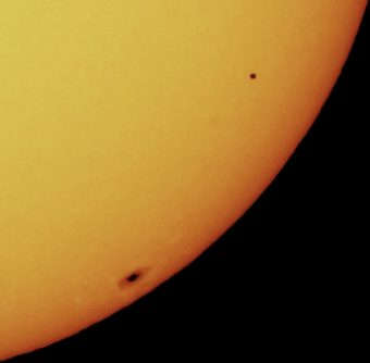 Mercurio in transito davanti al Sole nel 2006, evento che non fu visibile dall'Italia. Il pianeta è il puntino nero in alto sulla destra. Si noti come la sua dimensione apparente è nettamente inferioe a quella della macchia solare in basso, in prossimità del limbo della nostra stella. Crediti: edhiker 